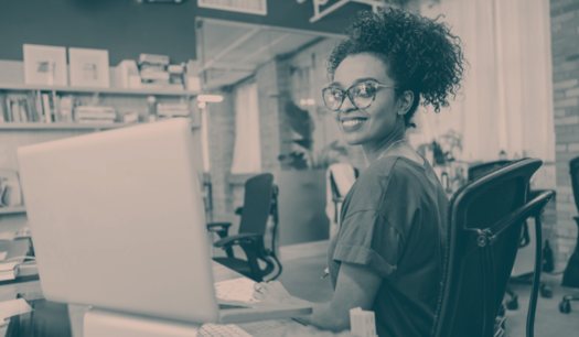 woman with glasses on the computer